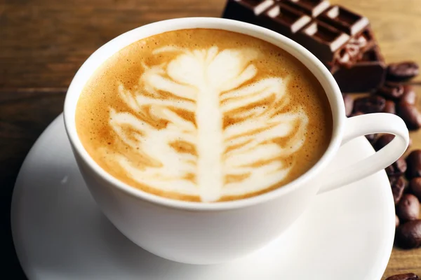 Cup of coffee latte art on wooden table, closeup — Stock Photo, Image