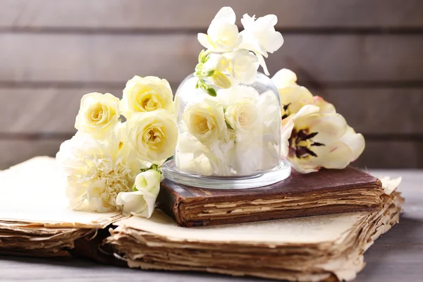 Hermosa composición con flores y libros antiguos sobre fondo de madera gris —  Fotos de Stock