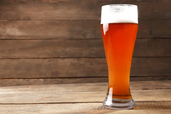 Glass of beer on wooden background — Stock Photo, Image