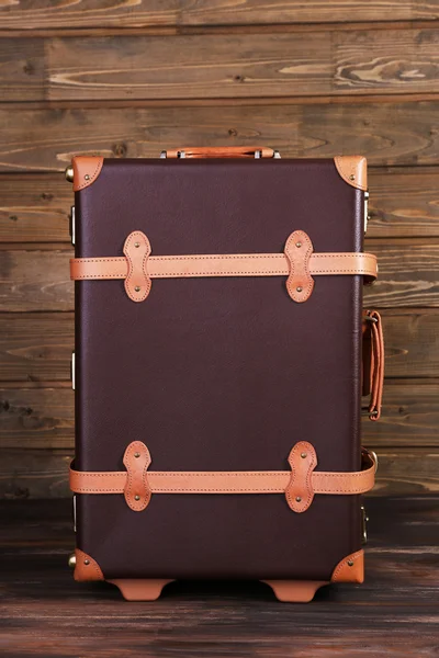 Suitcase on wooden background — Stock Photo, Image