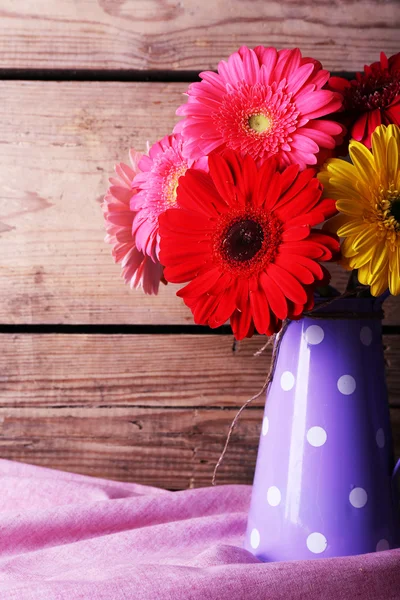 Still life with beautiful bright gerbera flowers on wooden background — Stock Photo, Image