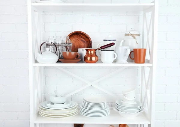 Estantería de cocina con platos sobre fondo de pared de ladrillo blanco —  Fotos de Stock