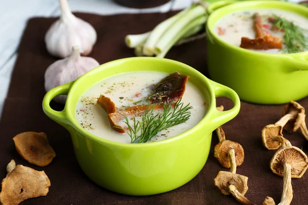 Mushroom soup with greens on color napkin, closeup — Stock Photo, Image