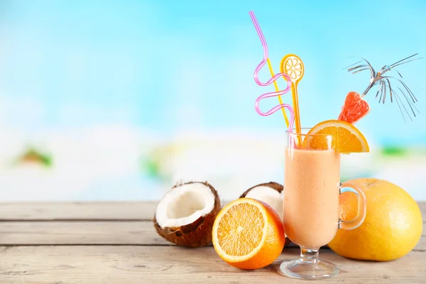 Glass of summer cocktail on wooden table on bright blurred background — Stock Photo, Image