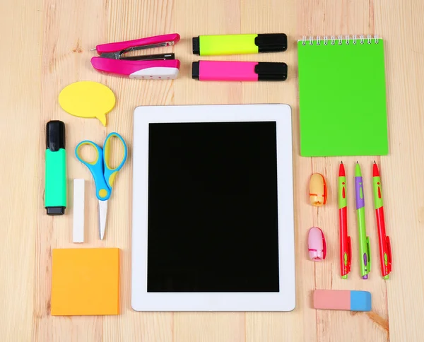 Digital tablet with stationery on wooden background — Stock Photo, Image