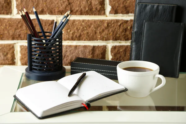 Stylish workplace at home or studio, on brown bricks background — Stock Photo, Image