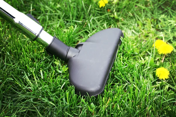 Metal pipe of vacuum cleaner in action - clean carpet of real green grass. Ecology concept — Stock Photo, Image