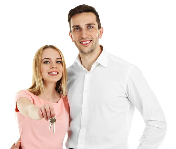 Attractive young couple showing new house key, isolated on white — Stock Photo, Image