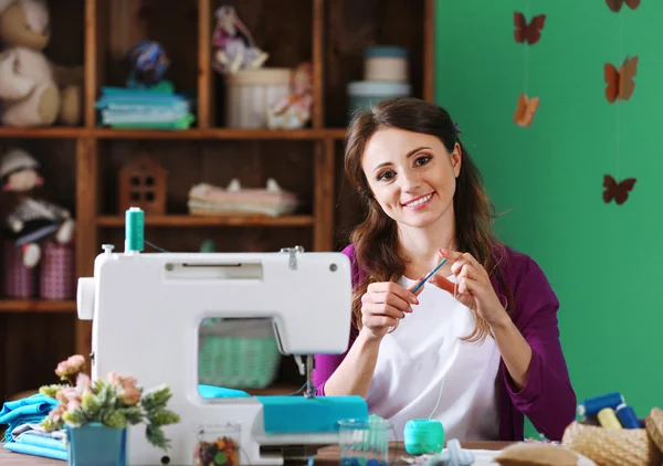 Beautiful young needlewoman in workshop — Stock Photo, Image