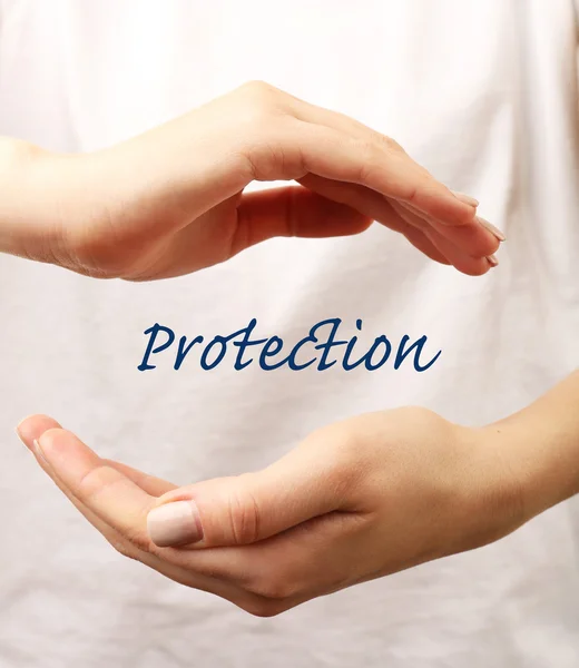 Female hands with word protection on light background — Stock Photo, Image