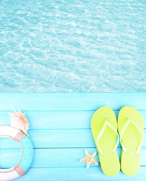 Female flip flops on wooden platform — Stock Photo, Image