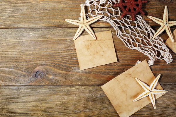 Card blanks with sea stars on wooden background — Stock Photo, Image