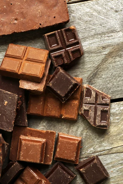 Set of chocolate on wooden table, closeup — Stock Photo, Image