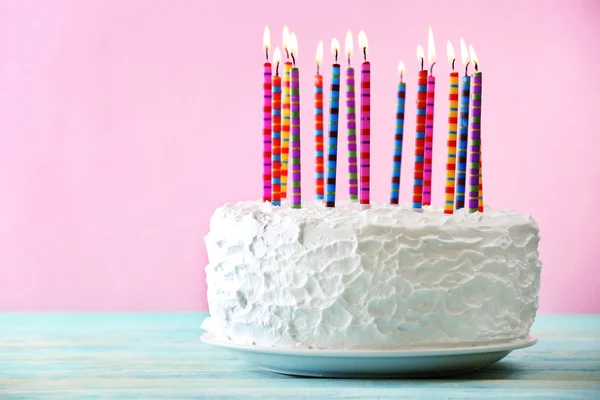 Birthday cake with candles on color background