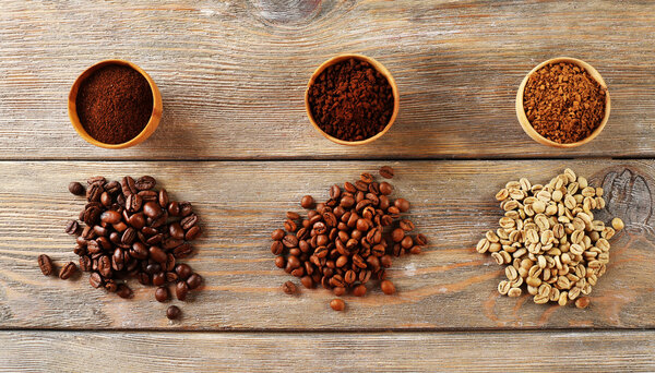 Various of coffee in small dishes on wooden table, top view