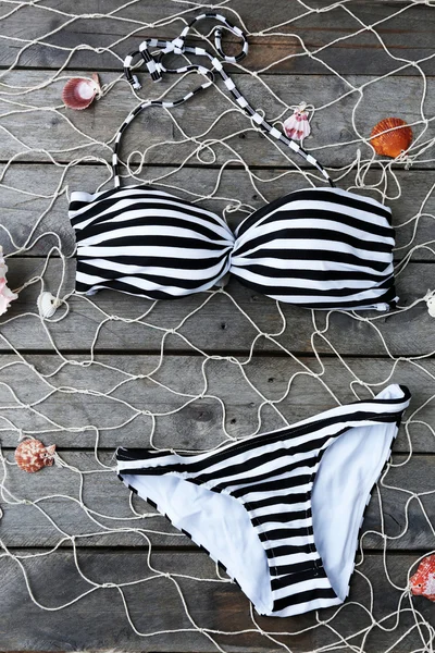Swimsuit on wooden background — Stock Photo, Image