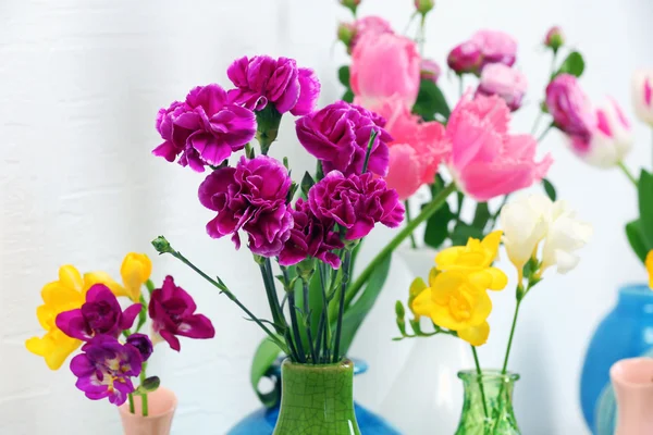 Different beautiful flowers in vases close up — Stock Photo, Image