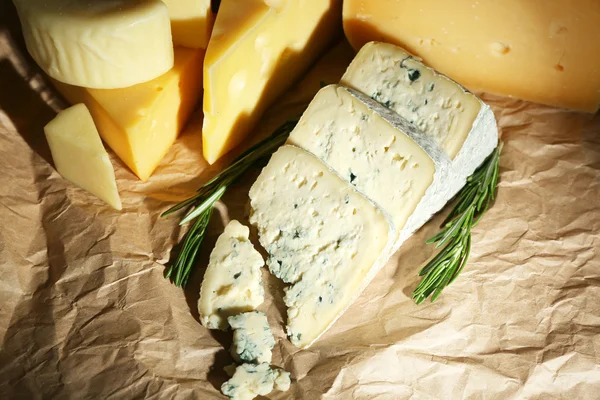 Vários tipos de queijo com alecrim na mesa de perto — Fotografia de Stock