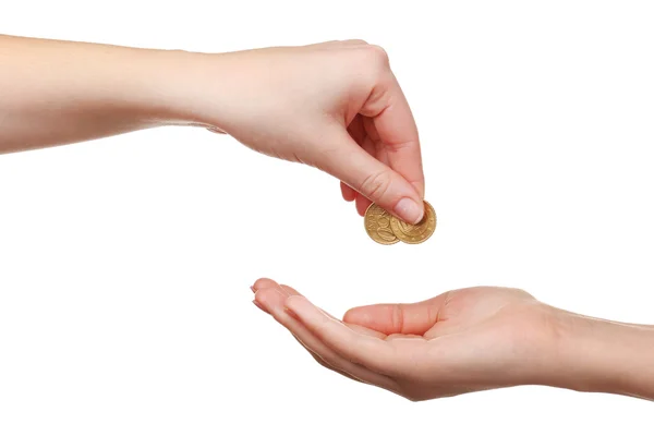 Mano femenina poniendo moneda en otra mano aislada en blanco — Foto de Stock