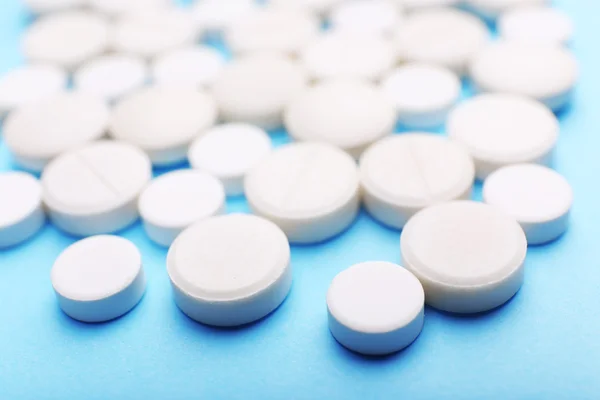 Pile of pills on color table, closeup — Stock Photo, Image