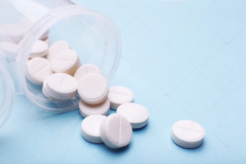 Heap of pills on color background