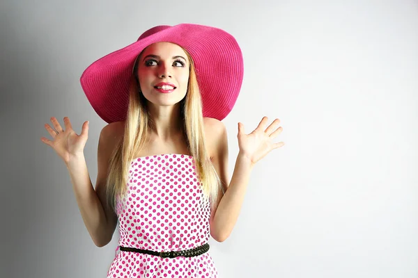 Expressive jeune modèle en chapeau rose sur fond gris — Photo