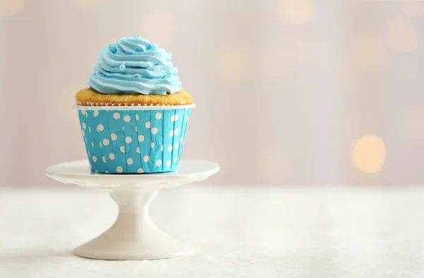 Sweet cupcake on table on light background — Stock Photo, Image