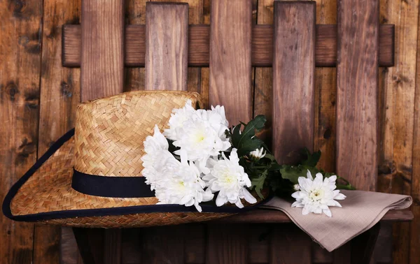 Hut mit Blumen auf Holzgrund — Stockfoto