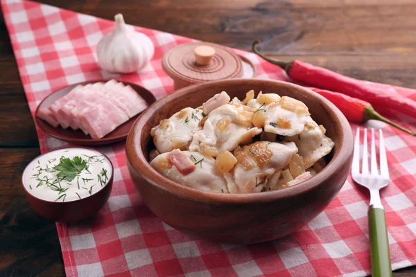 Sabrosas albóndigas con cebolla frita en tazón marrón, sobre fondo de madera — Foto de Stock