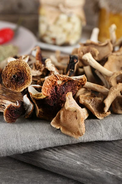 Dried mushrooms with spices on wooden background — Stock Photo, Image