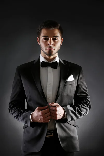 Elegant man in suit on dark background — Stock Photo, Image