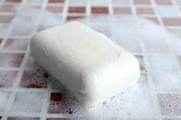 Soap with bubble on mosaic tiles background