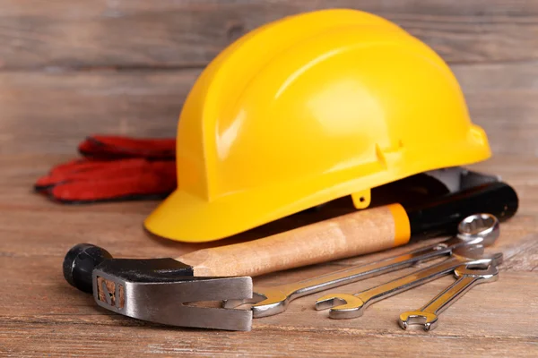 Construction tools with helmet on table close up — Stock Photo, Image
