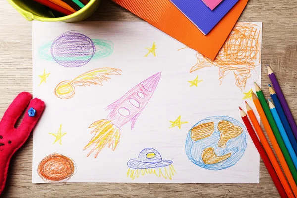 Kids drawing on white sheet of paper on wooden table, top view — Stock Photo, Image