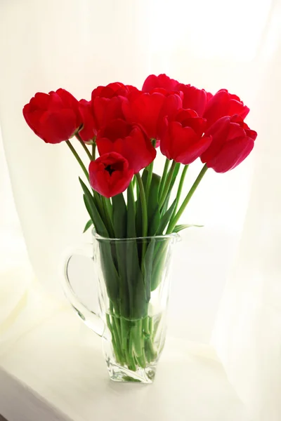 Bouquet of fresh tulips on windowsill background — Stock Photo, Image