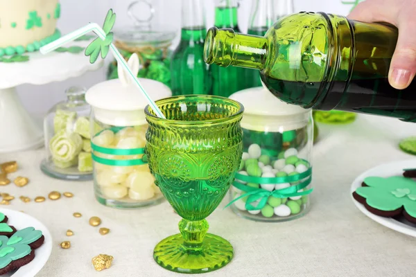Composition for St Patrick Day with sweets and drinks on table close up — Stock Photo, Image