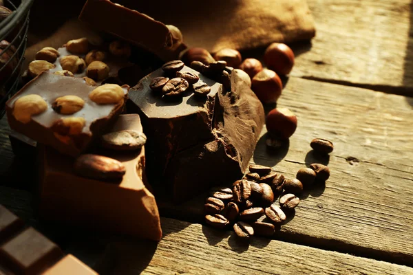 Still life with set of chocolate with nuts on wooden table, closeup — Stock Fotó