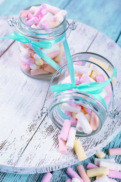 Sweet candies on color wooden table — Stock Photo, Image