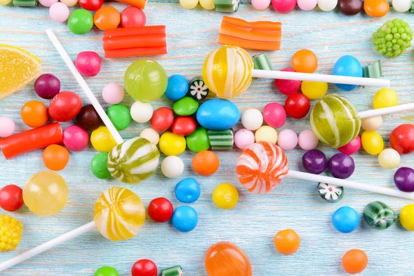 Colorful candies on wooden background — Stock Photo, Image