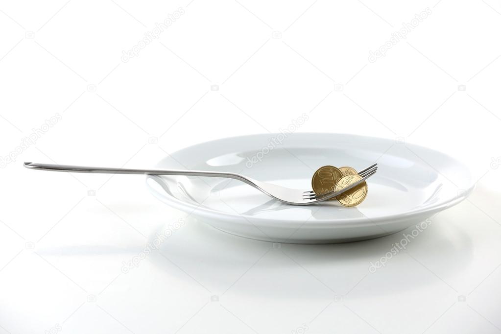 Coins on plate with fork isolated on white