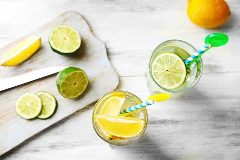 Cocktails with fresh citrus fruits on wooden background