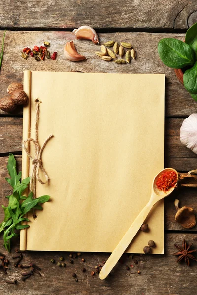 Open recipe book with fresh herbs — Stock Photo, Image