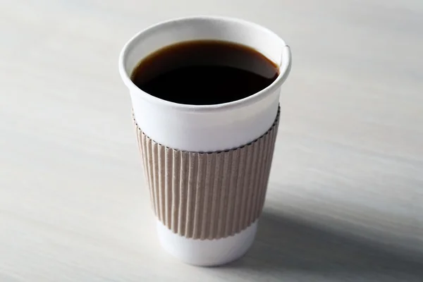 Paper cup of coffee on wooden background — Stock Photo, Image