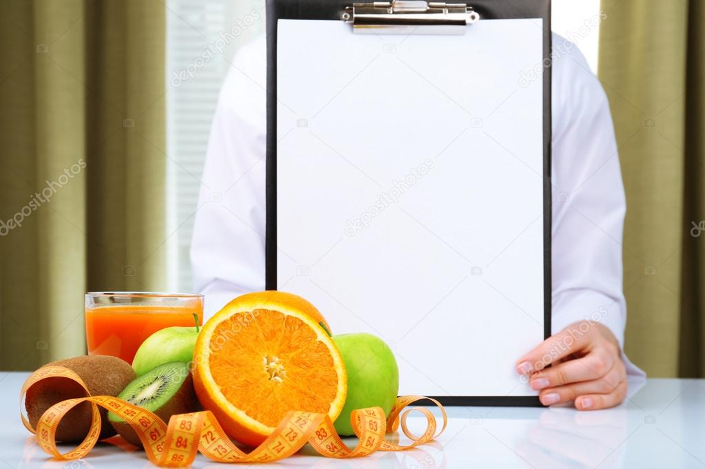 Nutritionist doctor with clipboard for diet plan in office