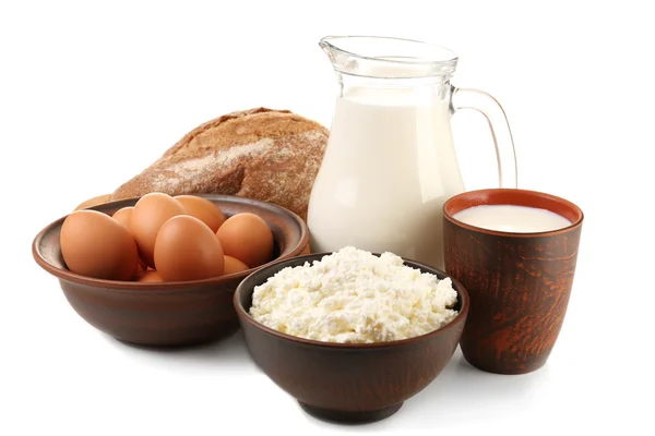 Cottage cheese, milk and eggs with loaf of bread isolated on white — Stock Photo, Image