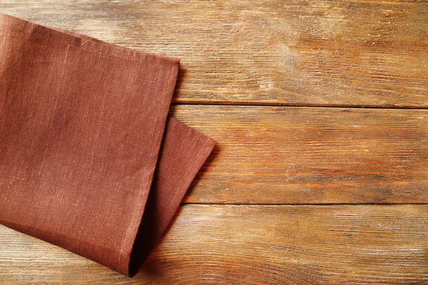 Napkin on wooden table — Stock Photo, Image