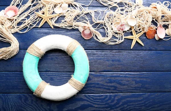 Beautiful sea composition with lifebuoy and shells on wooden background — Stock Photo, Image