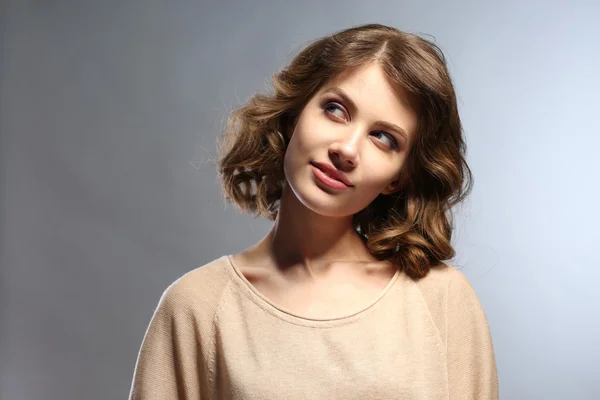 Portrait of beautiful model on gray background — Stock Photo, Image