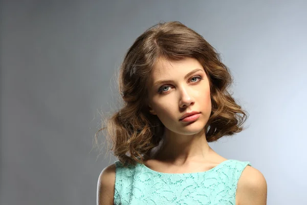 Portrait of beautiful model on gray background — Stock Photo, Image