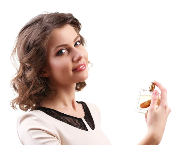 Mulher bonita com frasco de perfume isolado em branco — Fotografia de Stock